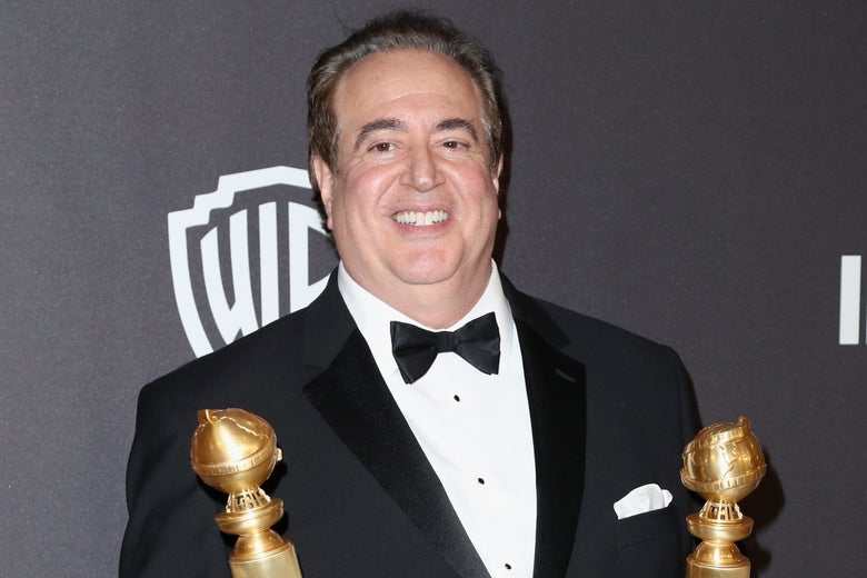 Nick Vallelonga holding his Golden Globes.